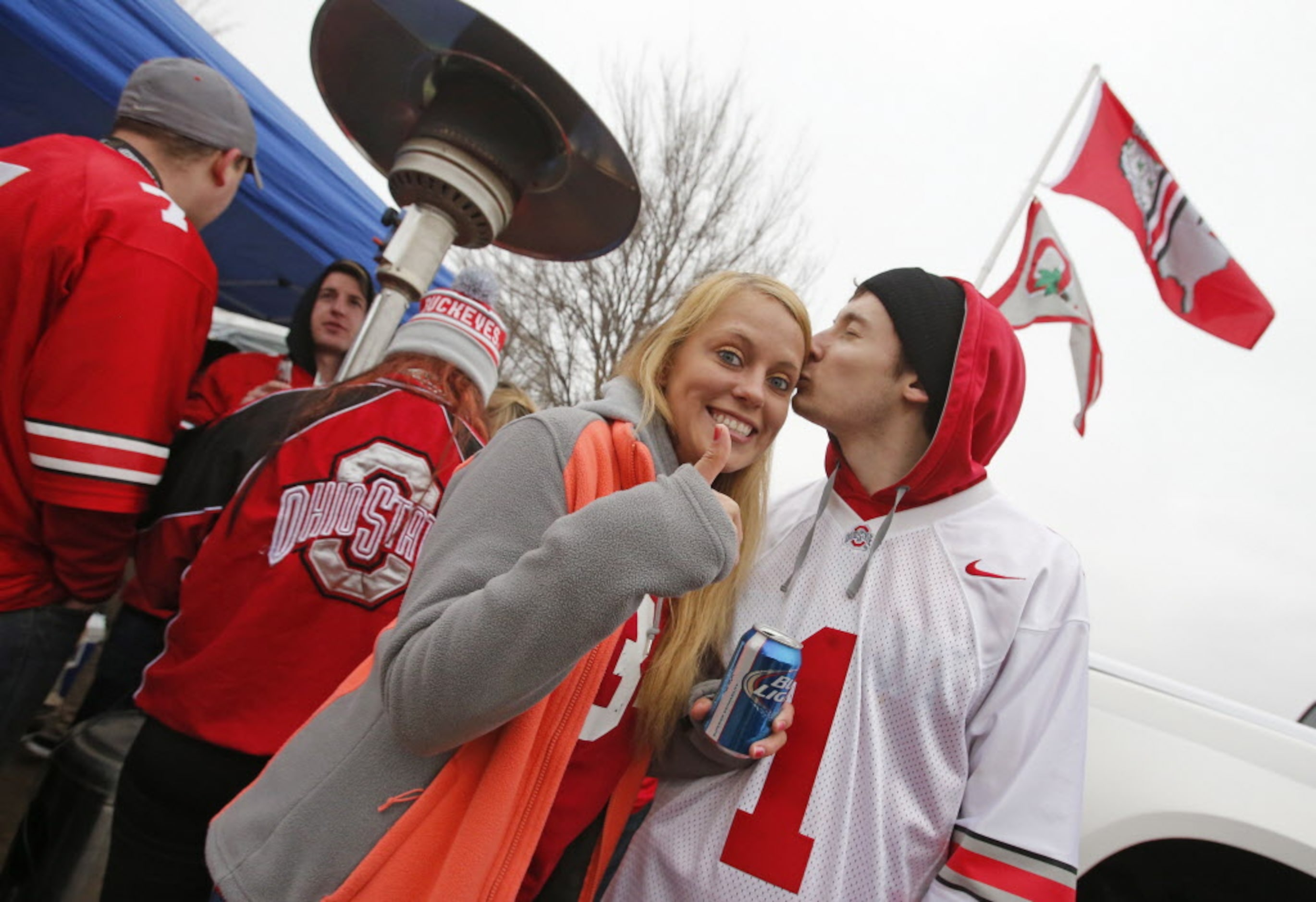 Nick Wagner sneaks a quick kiss with Kelsey Applehann as they tailgate before the College...