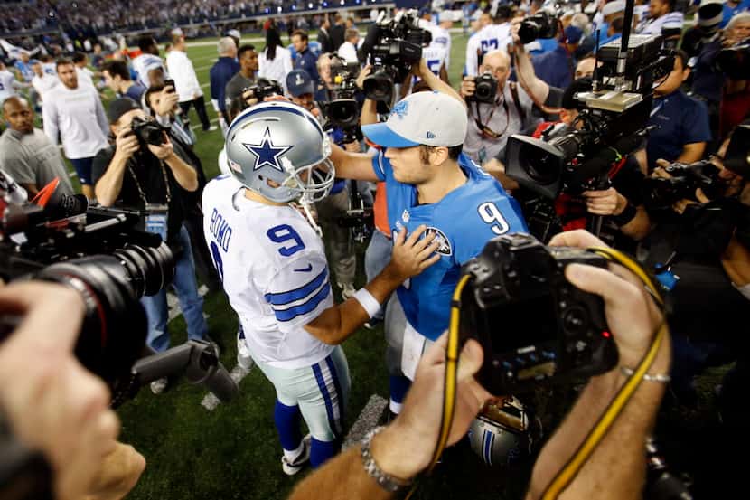 Dallas Cowboys quarterback Tony Romo (9) talks with Detroit Lions quarterback Matthew...