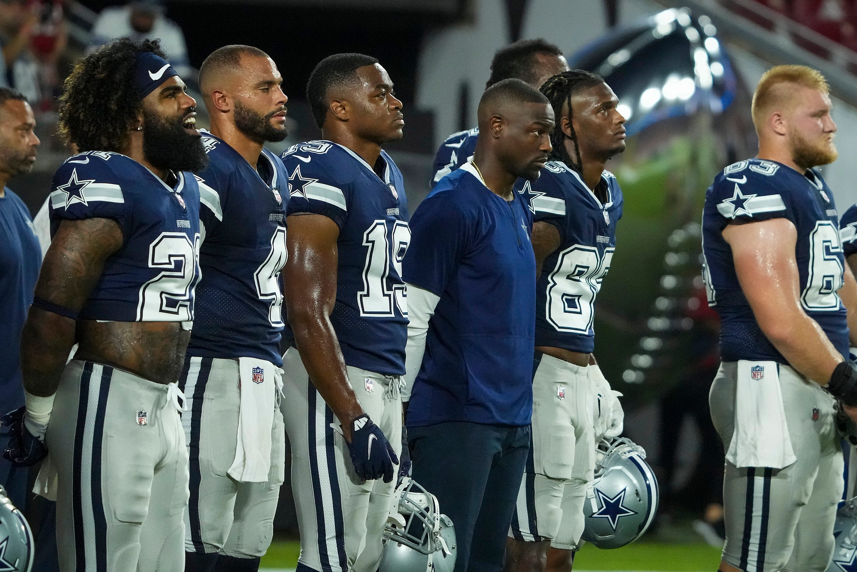 Dallas Cowboys running back Ezekiel Elliott (21) sings along with the playing of “Lift Every...