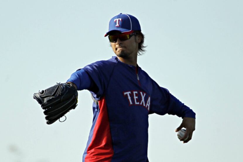 Texas Rangers pitcher Yu Darvish prepares to throw during spring training camp Wednesday,...