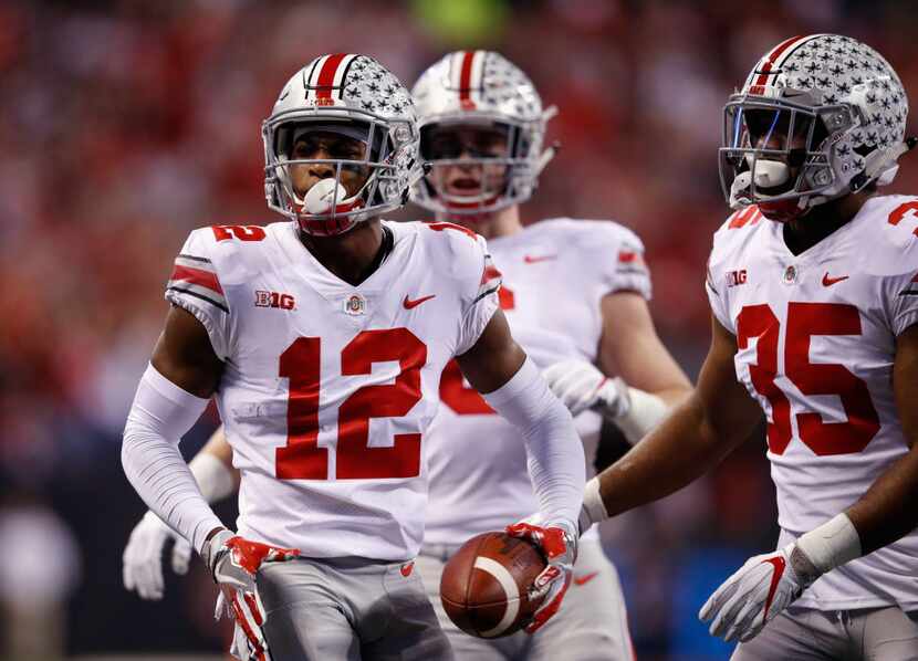 INDIANAPOLIS, IN - DECEMBER 02:  Denzel Ward #12 of the Ohio State Buckeyes celebrates an...