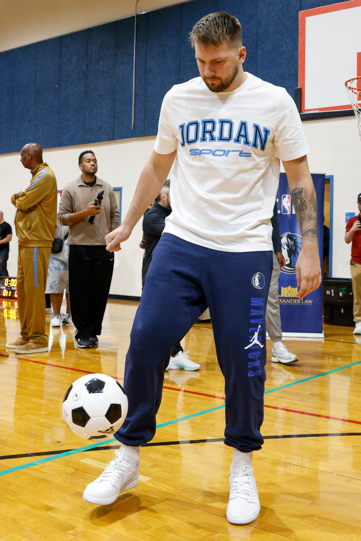 Dallas Mavericks guard Luka Doncic juggles a soccer ball during a children’s basketball...