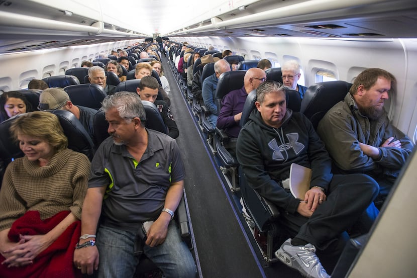 Passengers on a flight in Las Vegas, April 18, 2016. As planes fly at record capacity and...