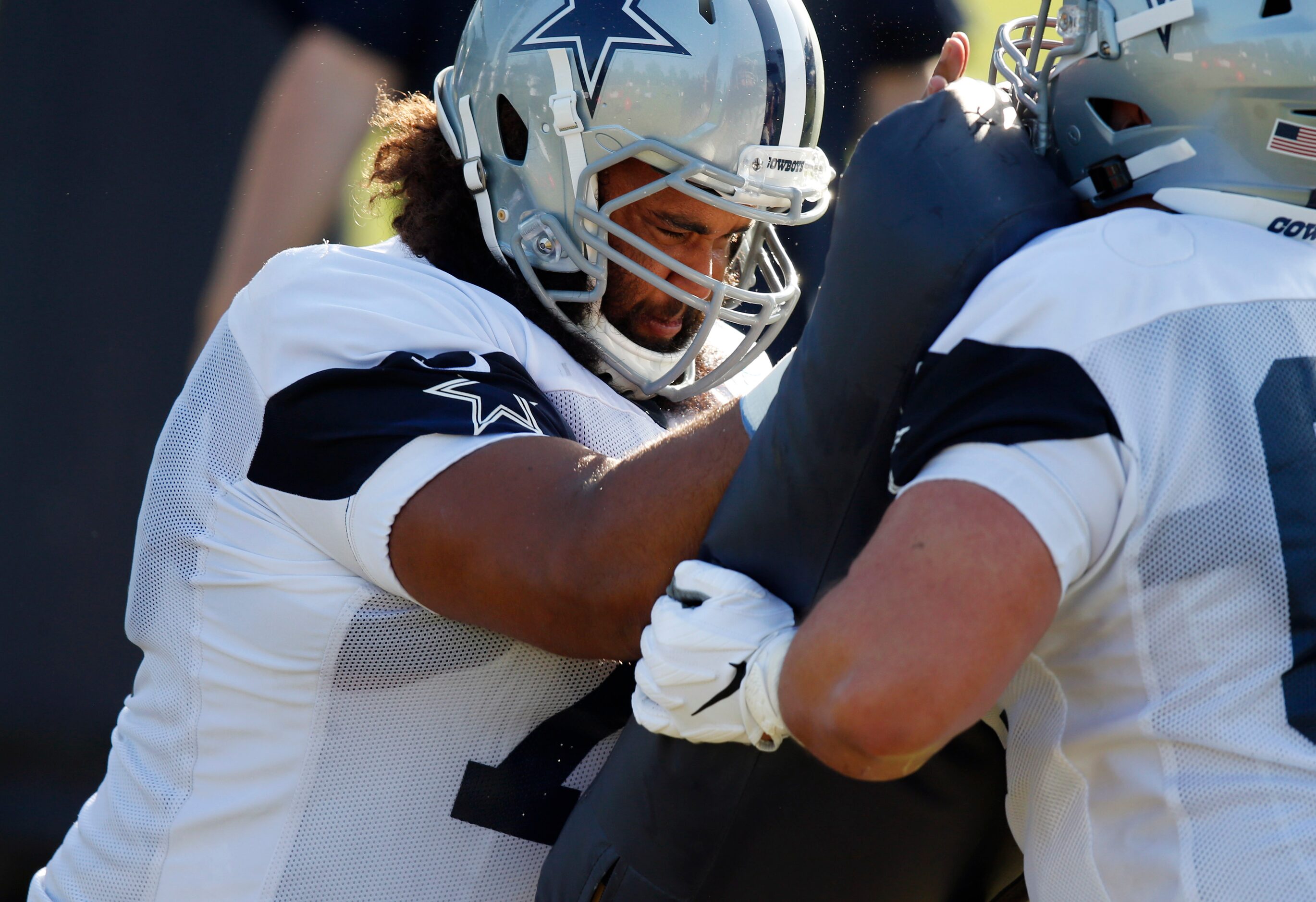 Dallas Cowboys center Joe Looney (73) runs through a drill with Dallas Cowboys center Marcus...