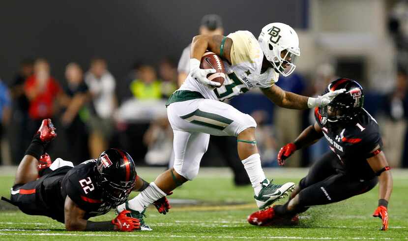 Baylor Bears running back Shock Linwood (32) is tripped by Texas Tech Red Raiders safety...