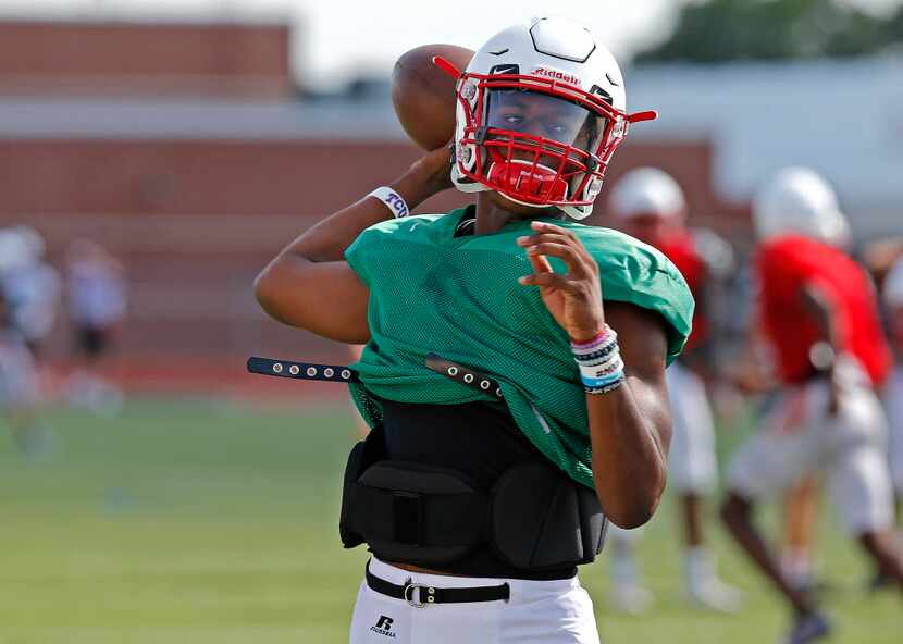 Quarterback Brendon Lewis throws a pass during football practice for Melissa High School at...