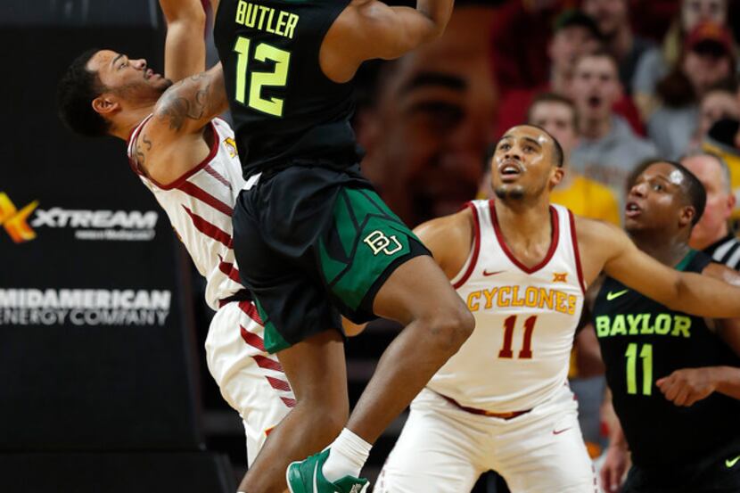 Baylor guard Jared Butler, center, drives to the basket for the shot as Iowa State guard...