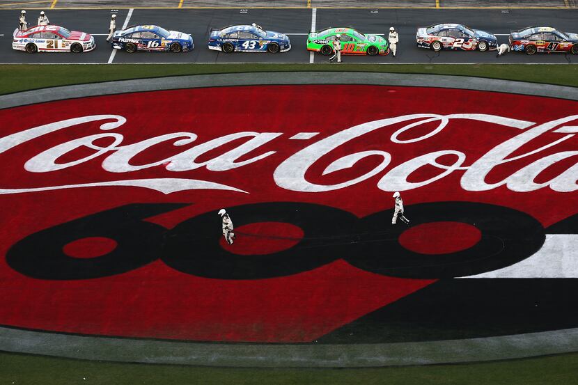 CONCORD, NC - MAY 26:  NASCAR Officials run to clean up cables from an aerial Fox Sports...