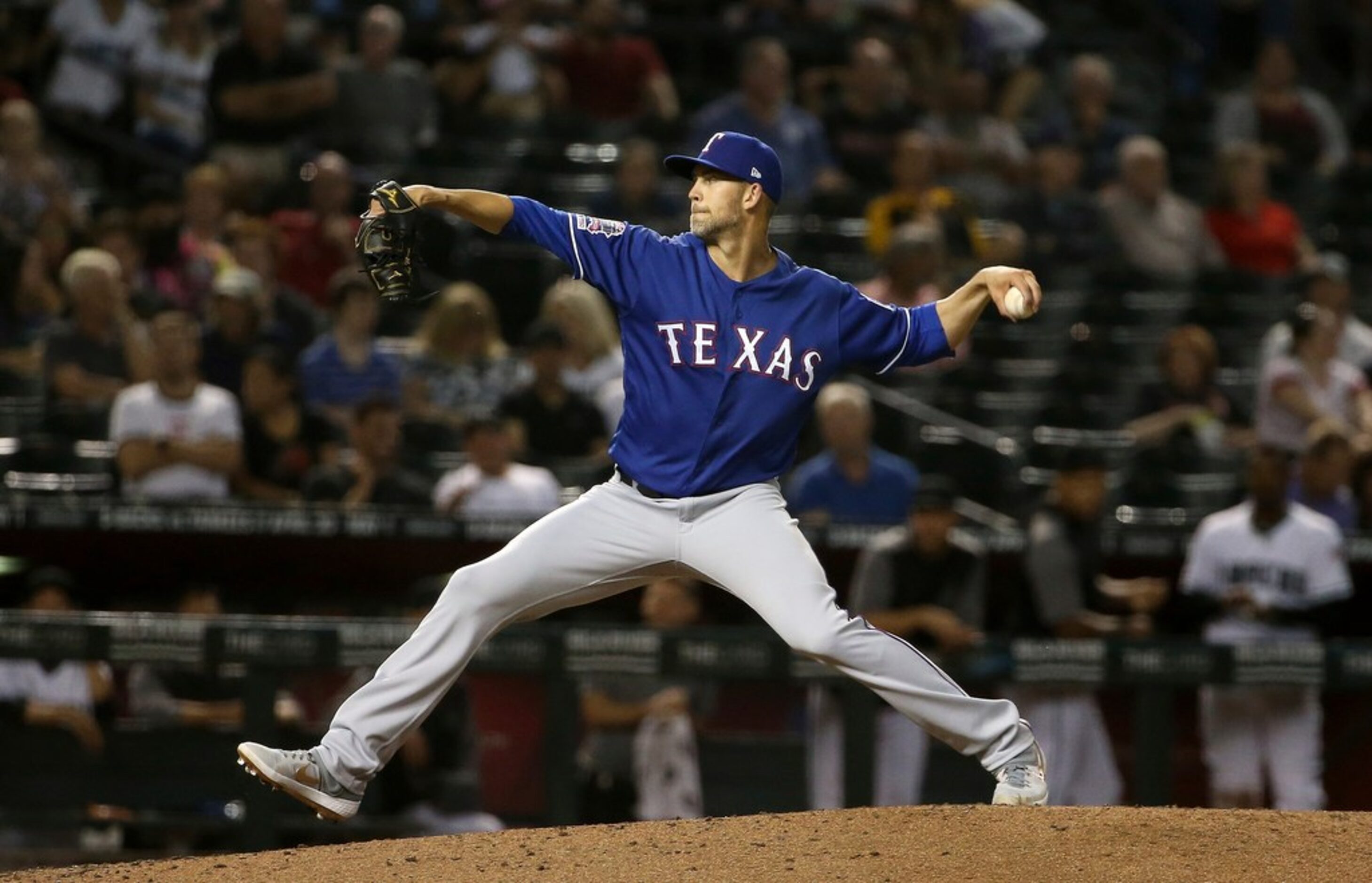 Texas Rangers starting pitcher Mike Minor, right, pauses on the mound after giving up a home...