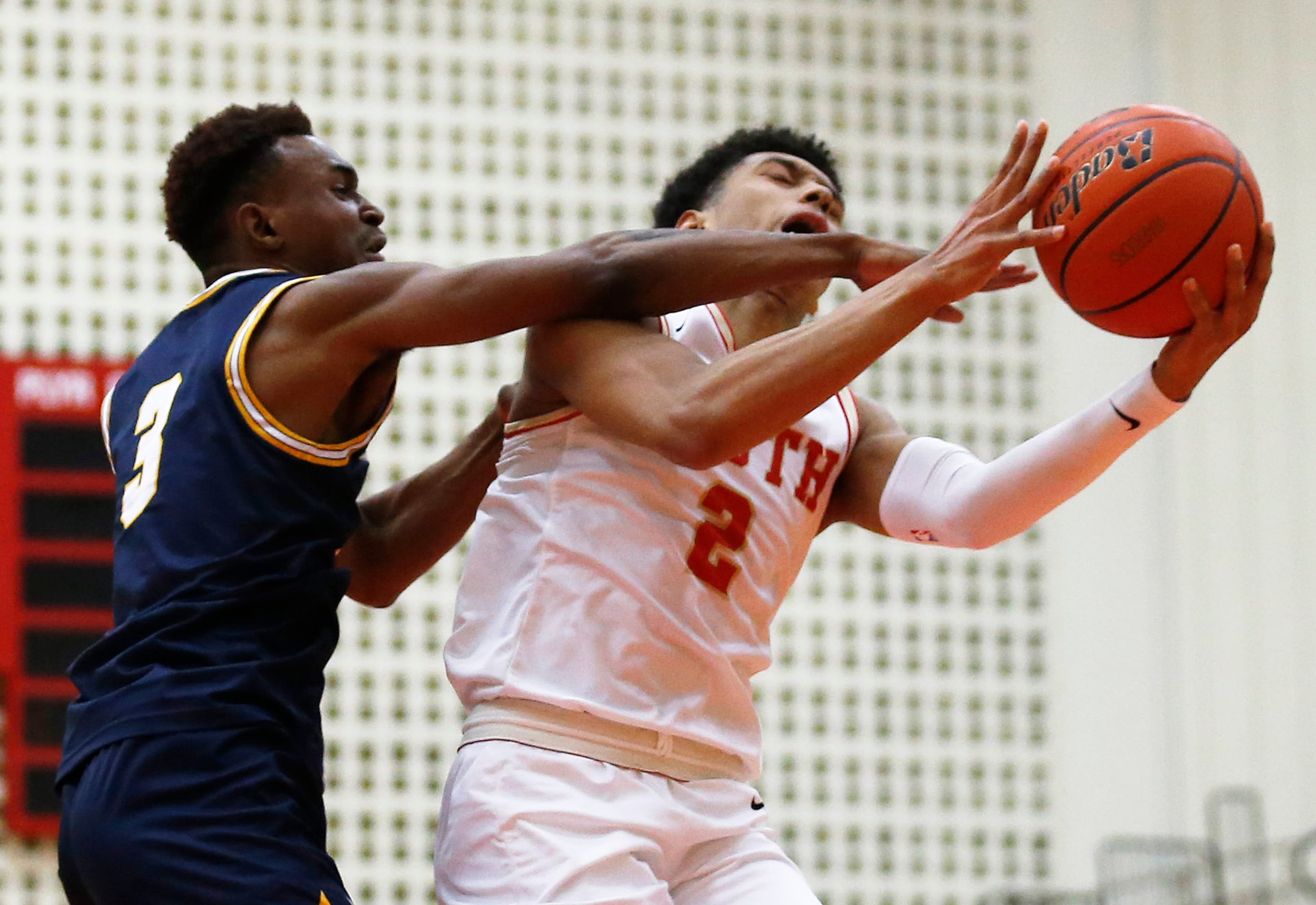 South Grand Prairie's Jordan Roberts (2) is fouled by  Arlington Lamar's Dorian Manigo (3)...