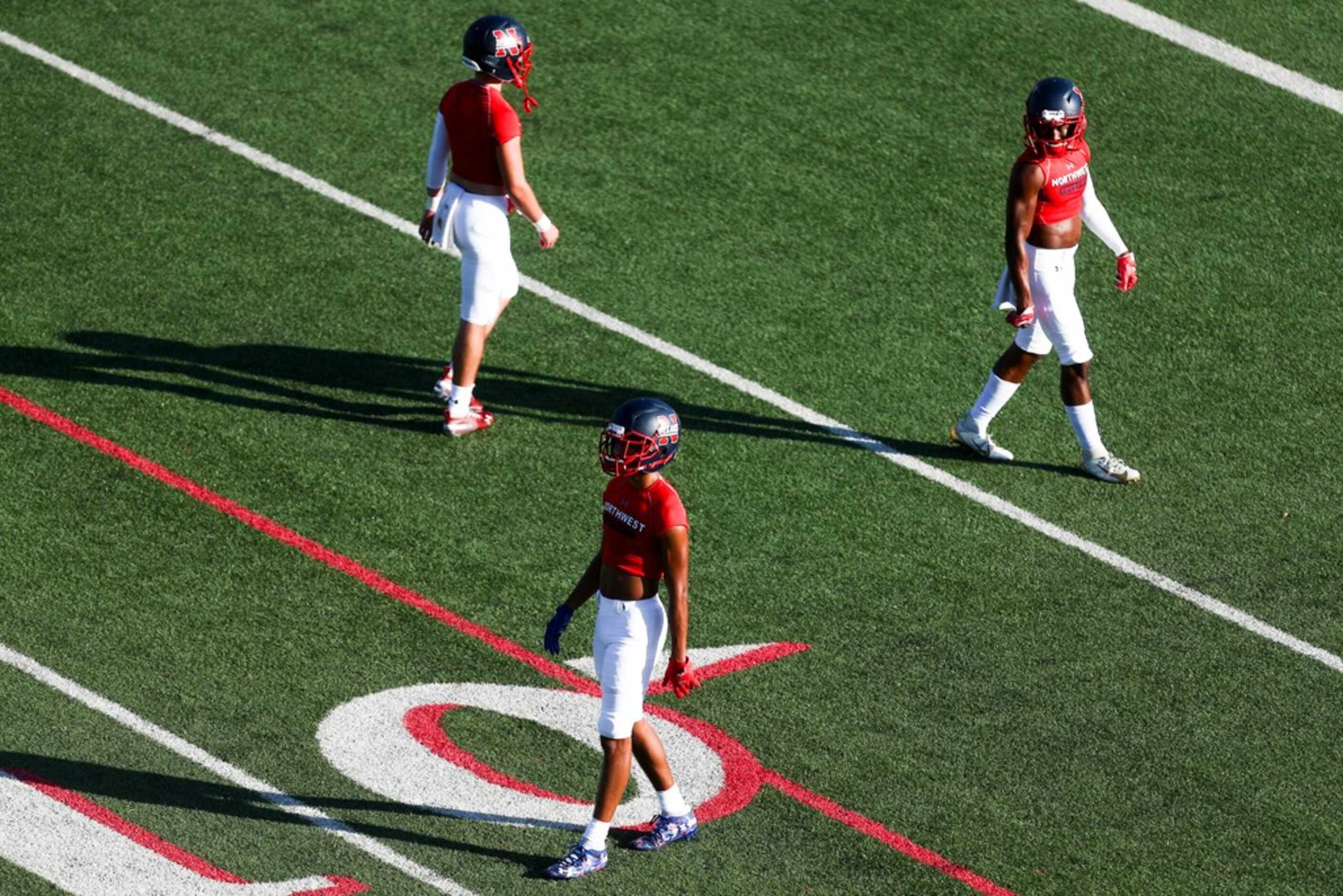 Northwest high school players warmup before a their game against Grapevine high schools at...