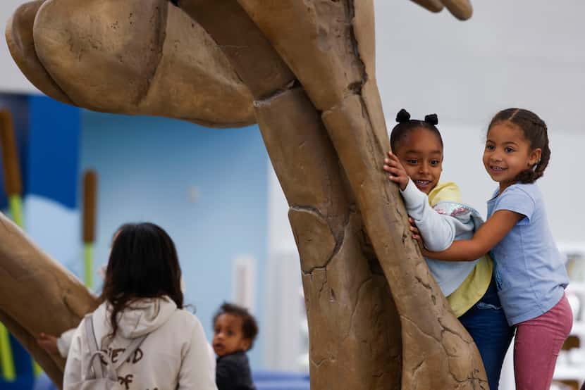 Mckinsey Youngblood, 6, and Alexis Lewis, 5, enjoy their time playing underneath Rexy, a...