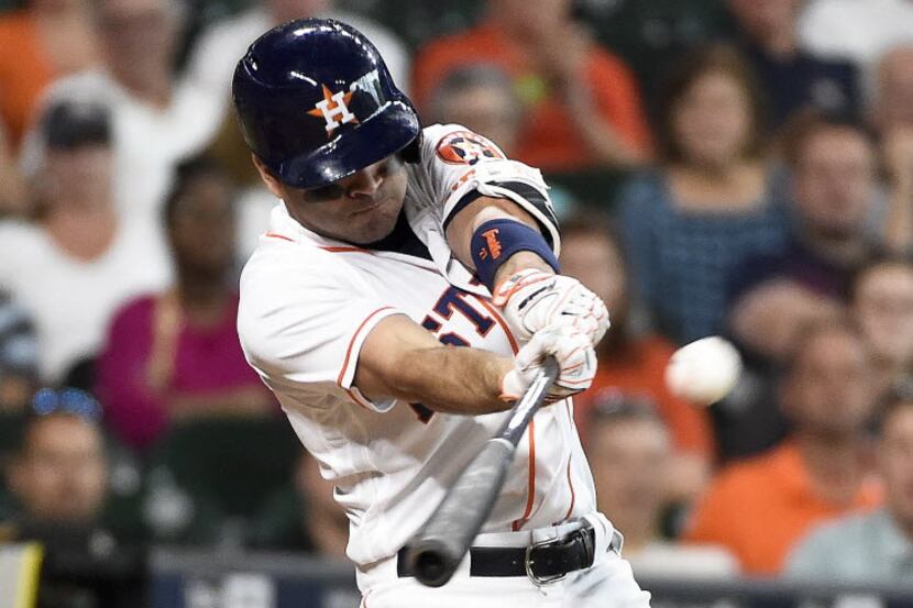 Houston Astros' Jose Altuve hits the game-tying RBI triple in the eighth inning of a...