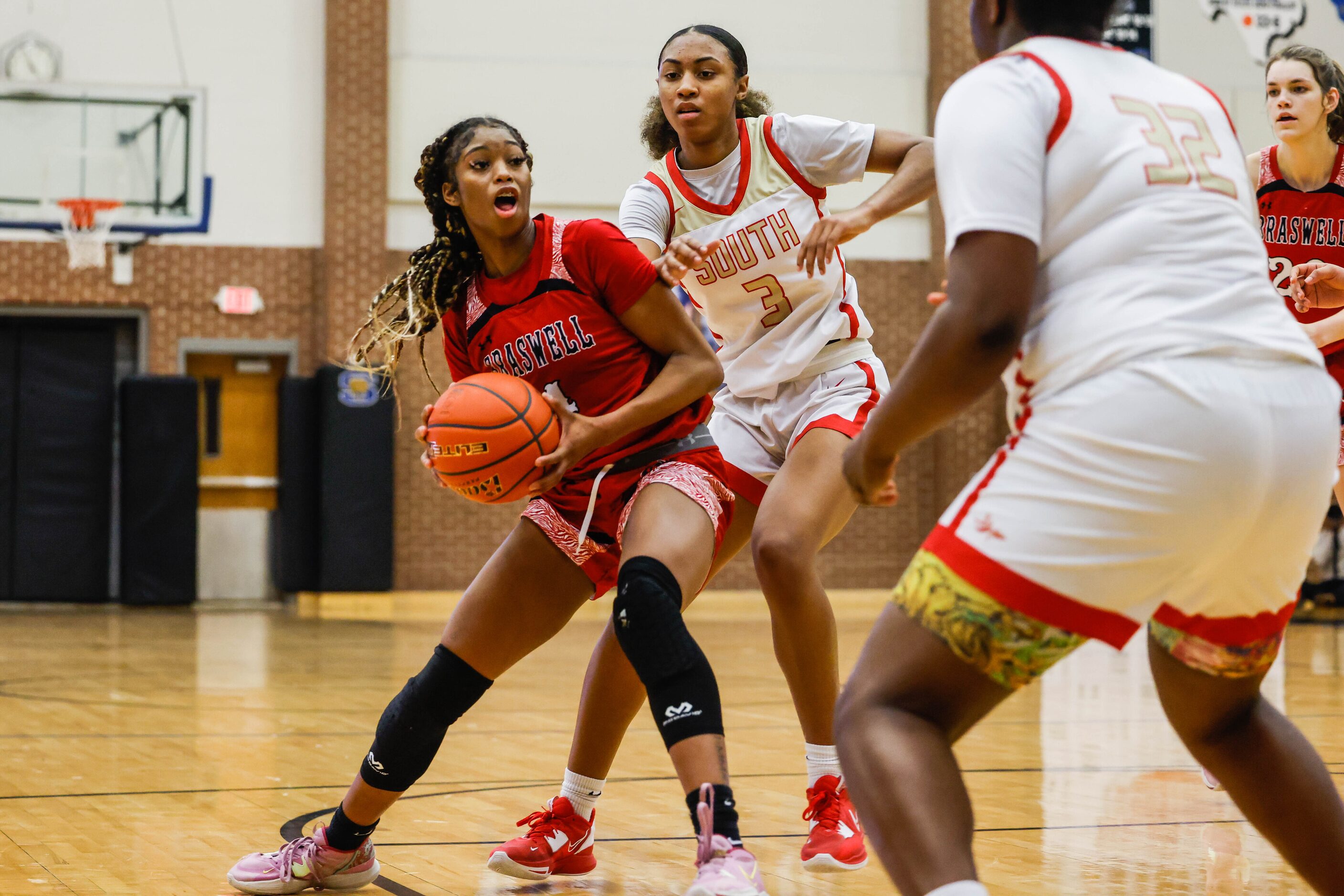 Denton Braswell's Kennedy Evans (4) goes South Grand Prairie's Taylor Barnes (3) during the...