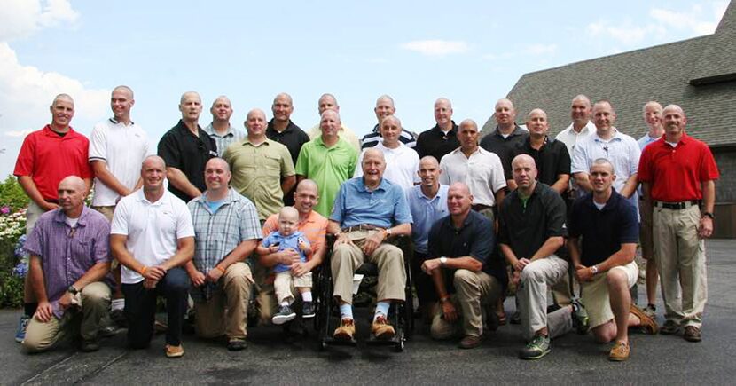 President George H. W. Bush and his security detail shaved their heads in a show of...