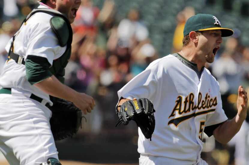 Oakland Athletics' Dallas Braden, right, celebrates with catcher Landow Powell after...