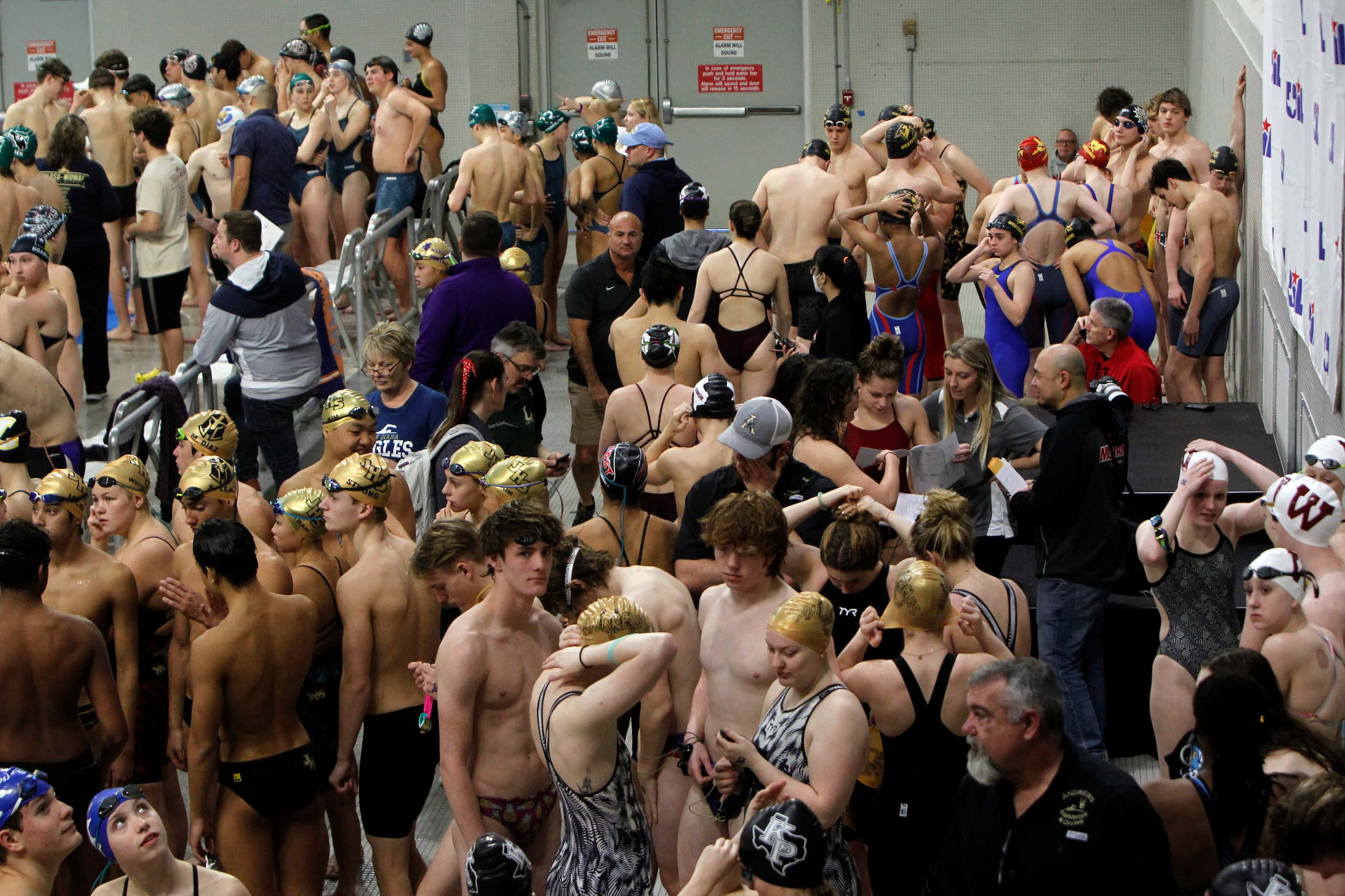 Boy and girl swimmers gather before the start of 5A competition. The first day of the UIL...