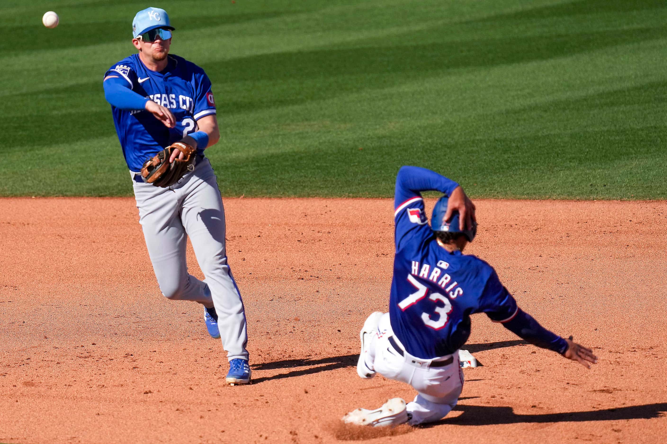 Texas Rangers outfielder Dustin Harris is out at second base as Kansas City Royals second...