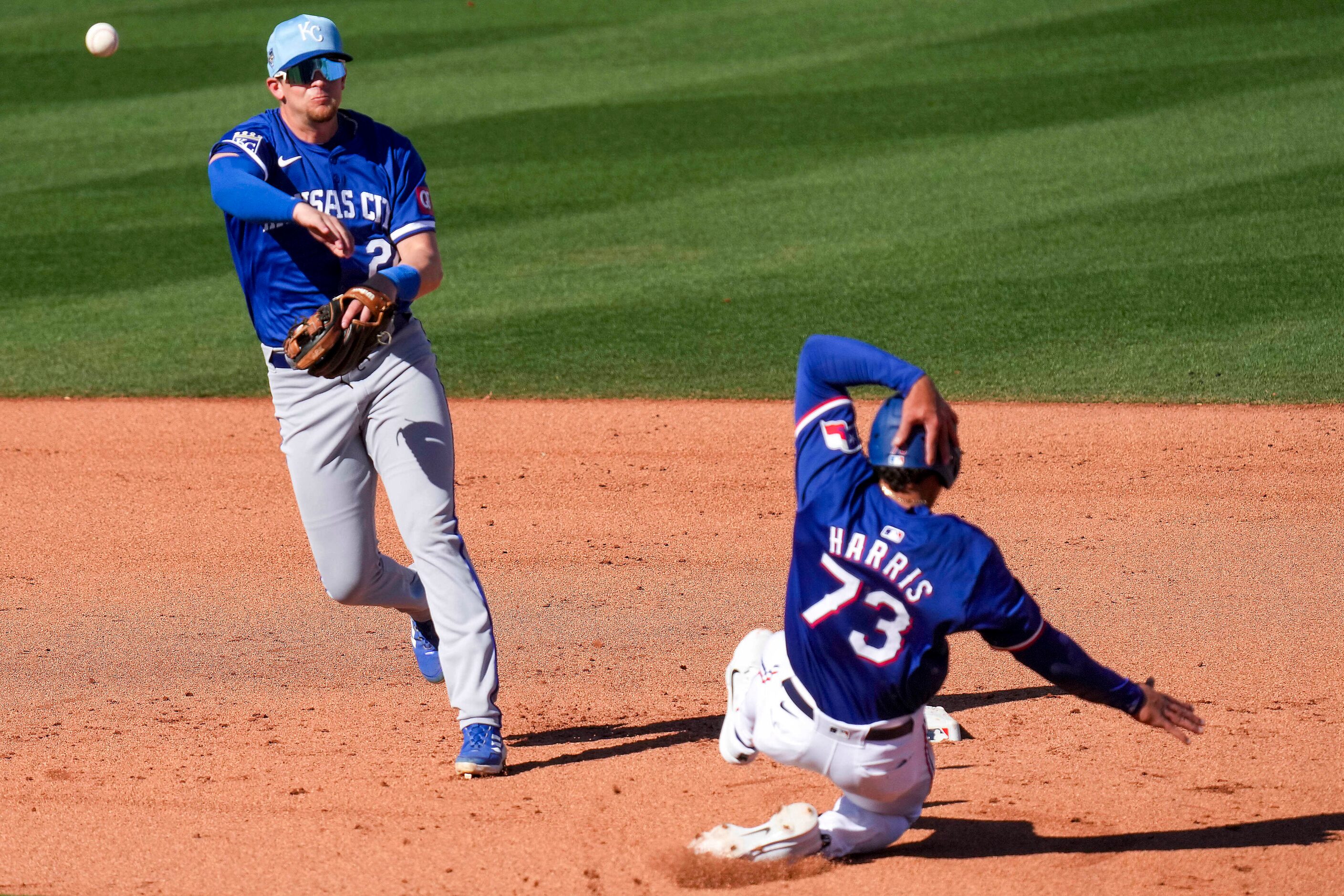 Texas Rangers outfielder Dustin Harris is out at second base as Kansas City Royals second...