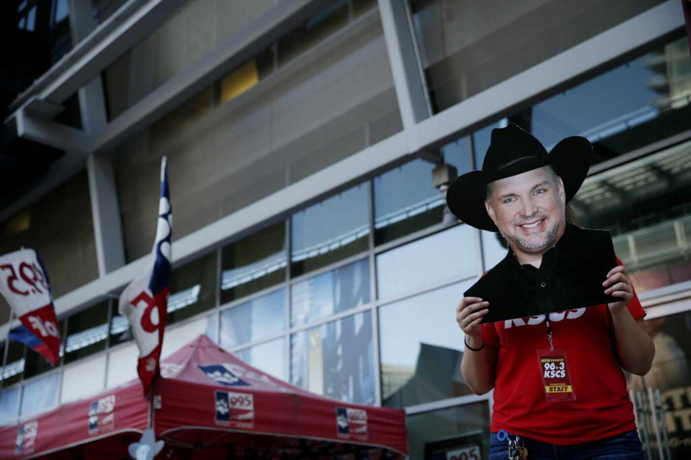 Radio employee Meagan Mahaffey poses with a poster of Garth Brooks in the plaza before...