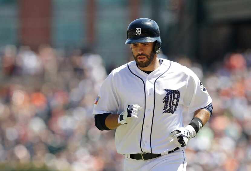 Detroit Tigers' J.D. Martinez runs back to the dugout during the eighth inning of a baseball...