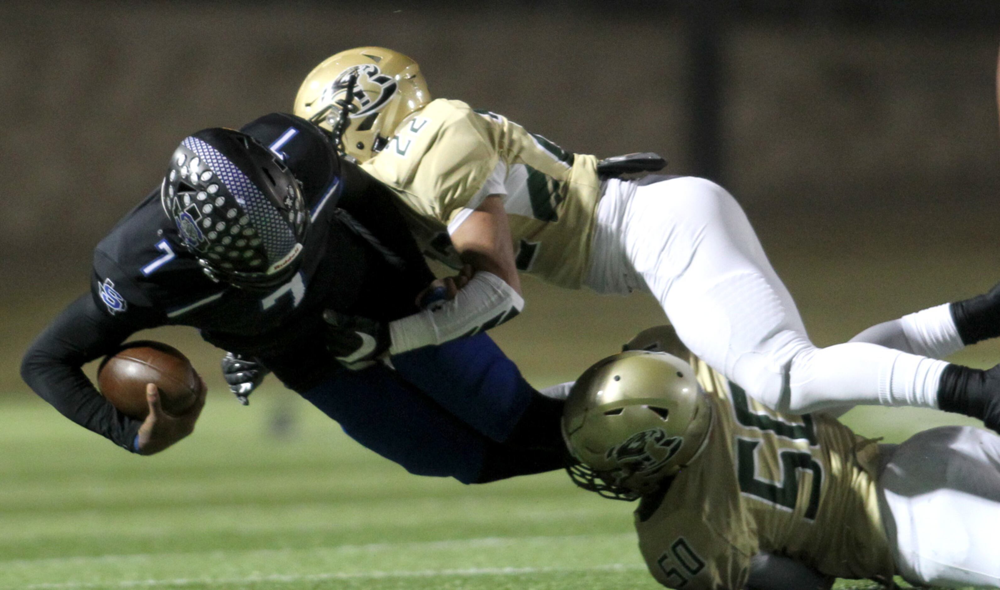 Mansfield Summit quarterback David Hopkins (7) is tackled after a short ground gain by...