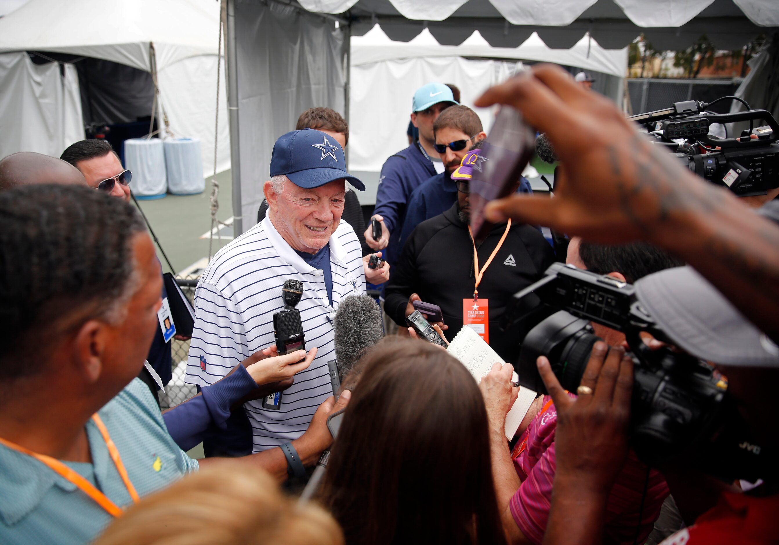 Dallas Cowboys owner Jerry Jones visits with reporters on the side following his kickoff...