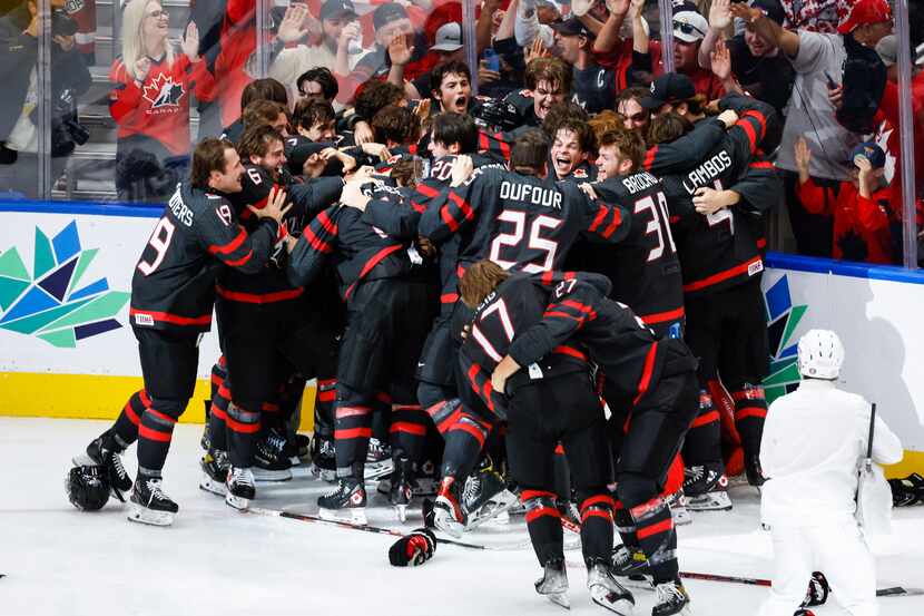 Canada celebrates defeating Finland during overtime in the gold medal game at the world...