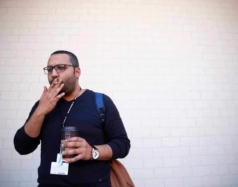 Mohamed Khattab, 27, smokes a cigarette outside El Centro College in downtown Dallas....