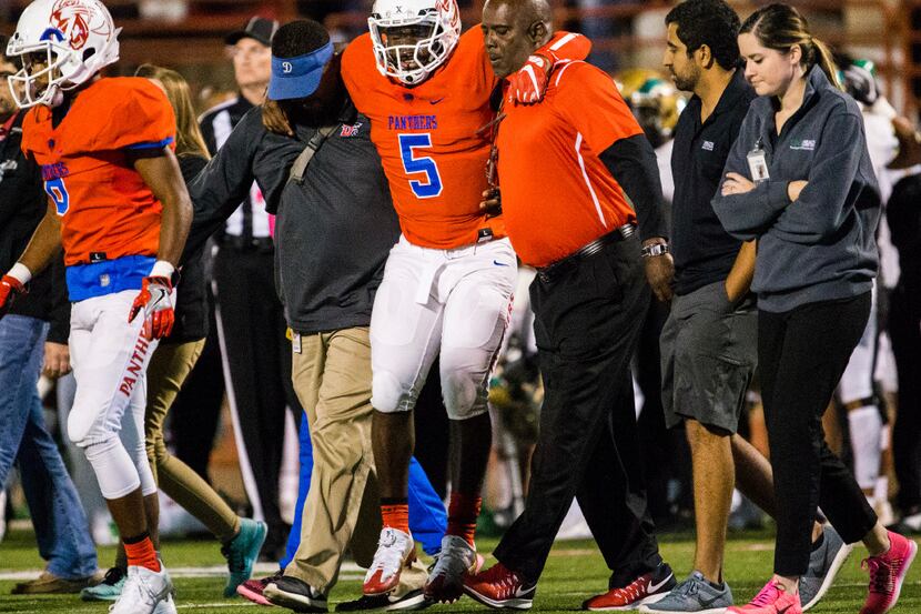 Duncanville quarterback Jaylin Nelson (5) is helped off the field after he was injured...