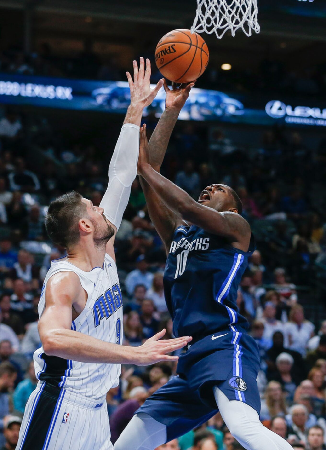 Dallas Mavericks forward Dorian Finney-Smith (10) fires up a shot past Orlando Magic center...