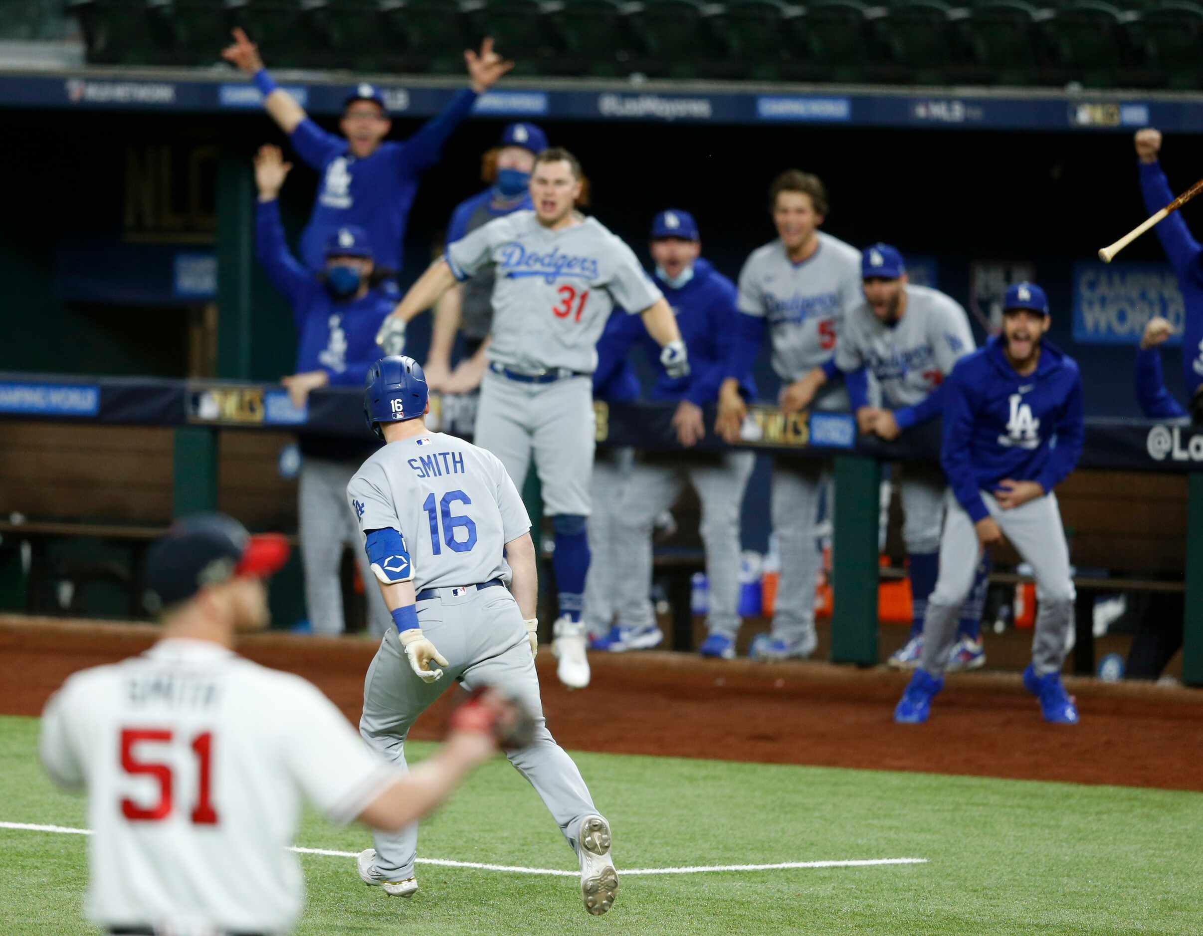 Los Angeles Dodgers catcher Will Smith (16) celebrates with teammates as he rounds the bases...