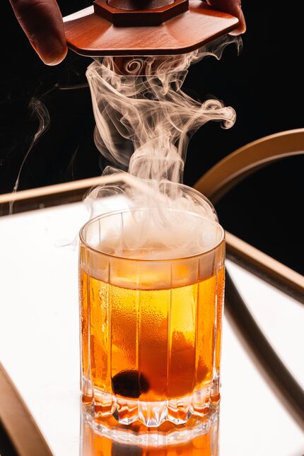 Paparazzi Chophouse's smoked old-fashioned puts on its own show. 