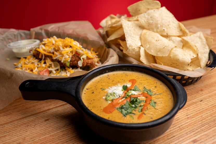 A Trailer Park taco, green chile queso and chips are served at Torchy’s Tacos.