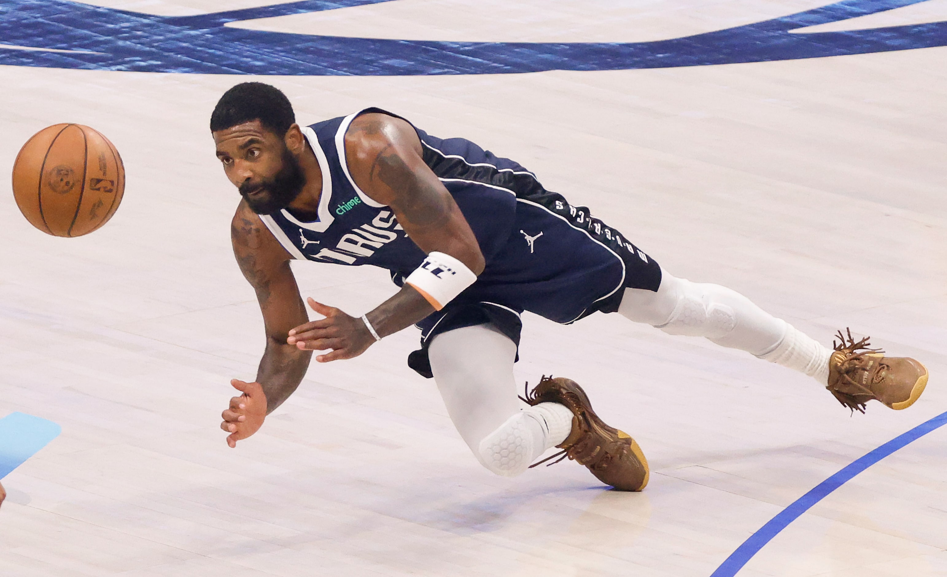 Dallas Mavericks guard Kyrie Irving (11) dives a loose ball against the Minnesota...