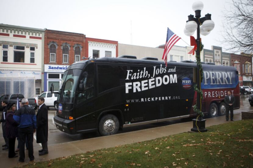 Rick Perry's bus, which stopped Wednesday in Harlan, Iowa, reflects the governor's new...