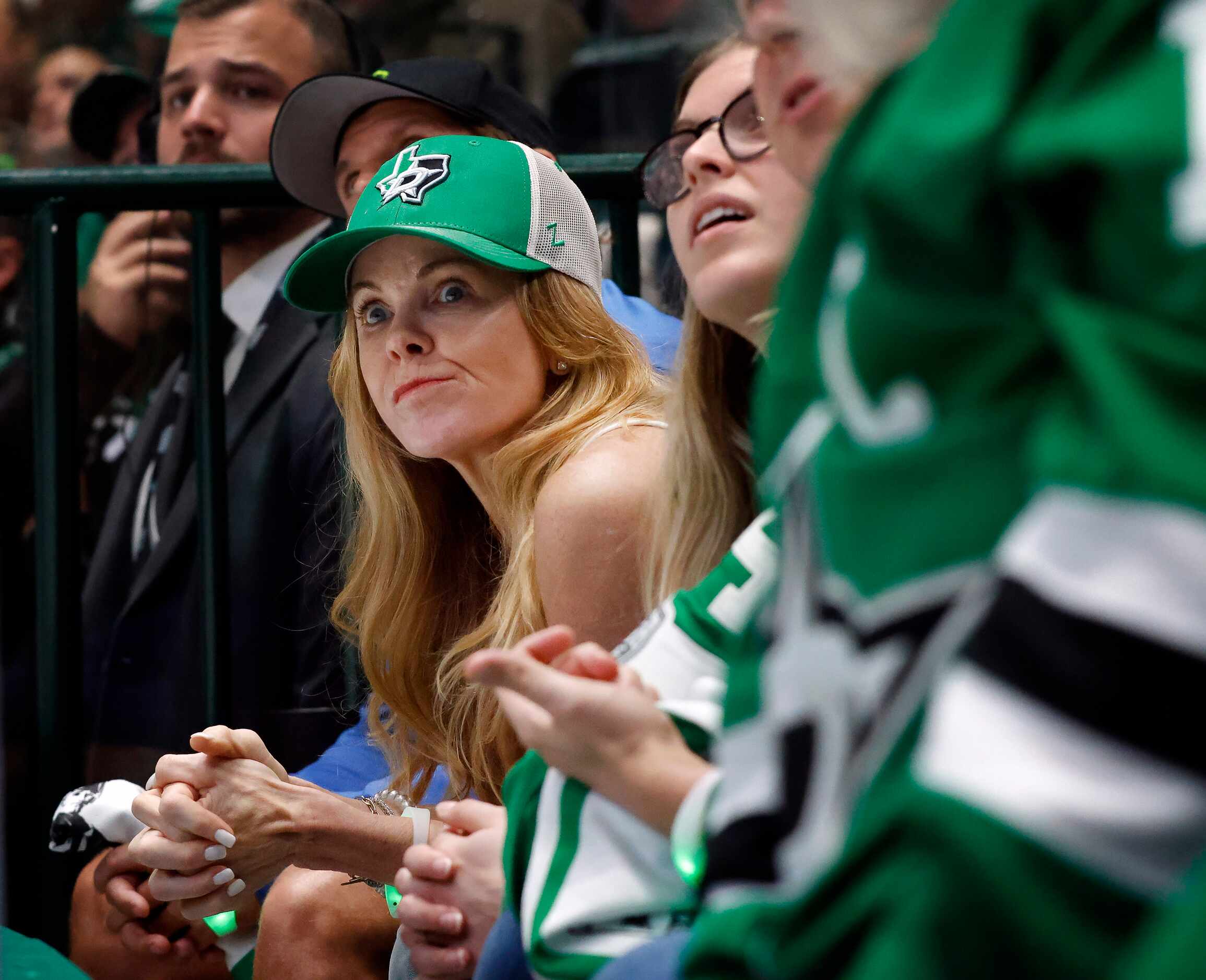 A Dallas Stars fan reacts to the team being scored on for the second time during the first...