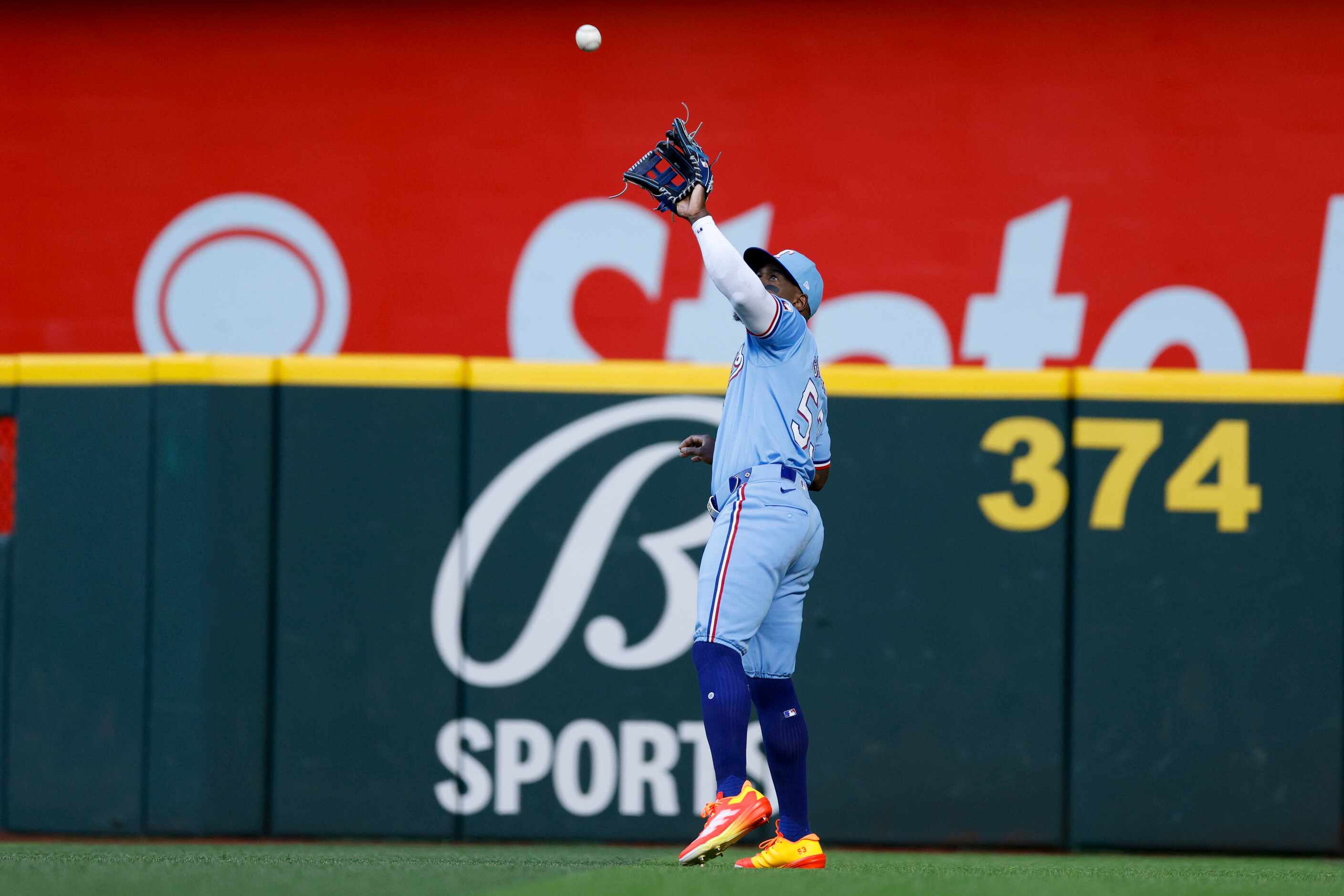 Texas Rangers right fielder Adolis García (53) makes a catch for an out during the first...