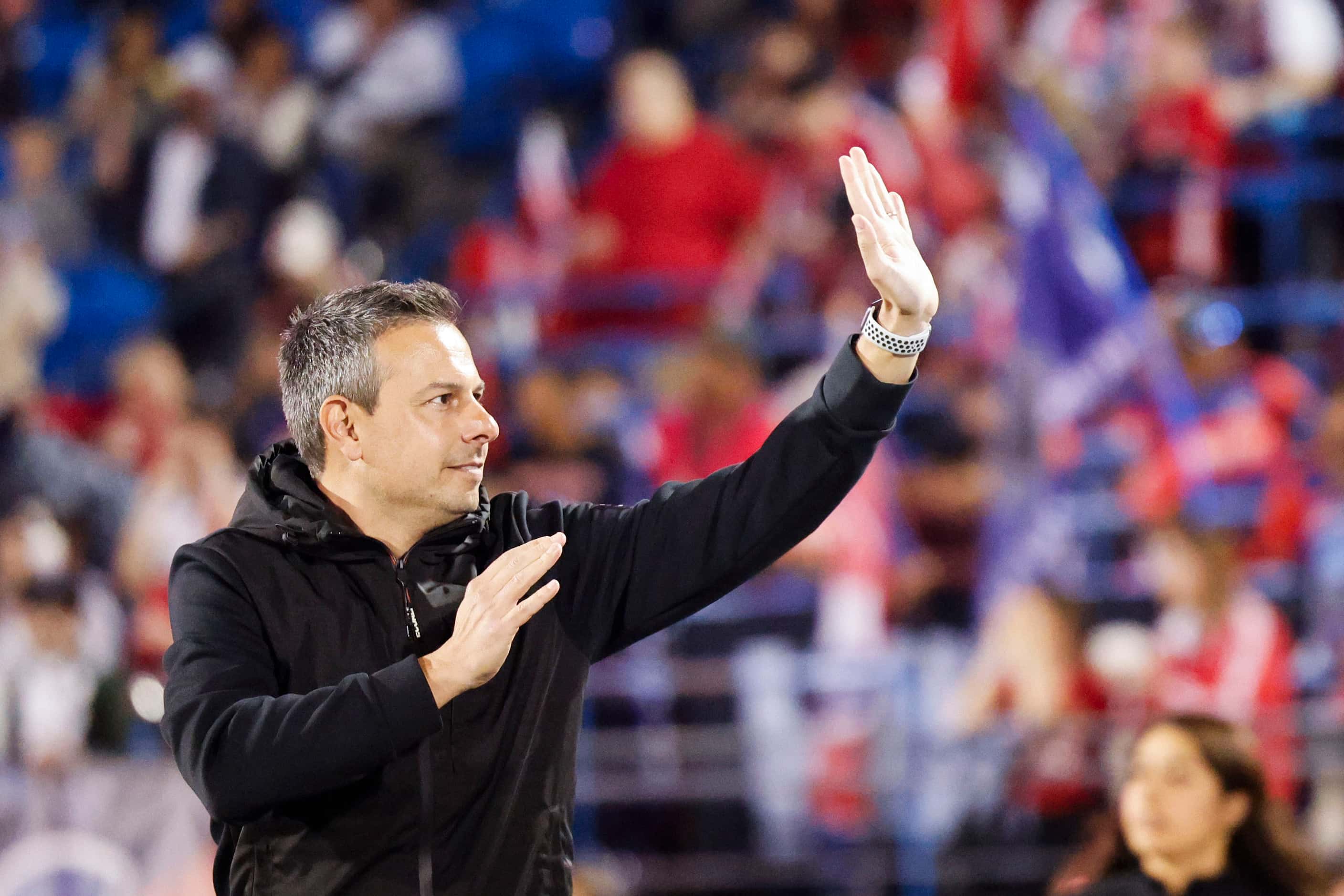 FC Dallas head coach Nico Estévez waves towards the crowd ahead of an MLS soccer match...
