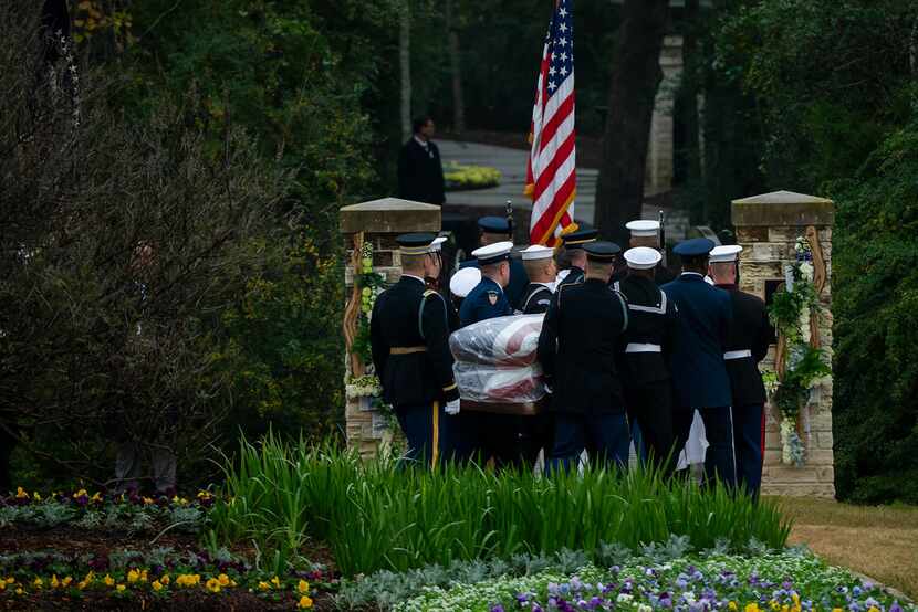 The flag-draped casket of President George H.W. Bush is carried to the burial plot close to...