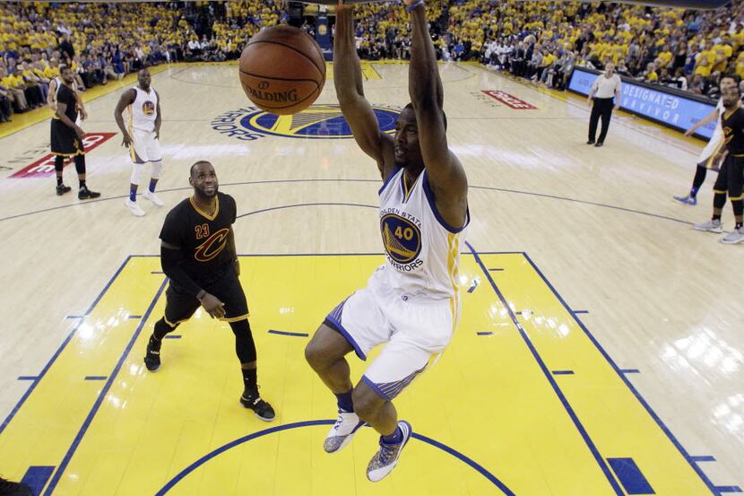 Golden State Warriors' Harrison Barnes (40) dunks past Cleveland Cavaliers' LeBron James...