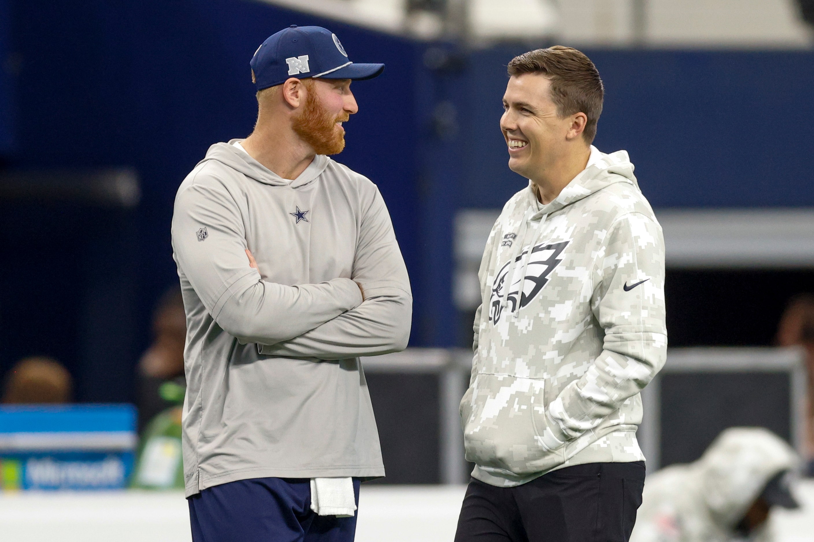 Dallas Cowboys quarterback Cooper Rush talks with former Cowboys offensive coordinator and...