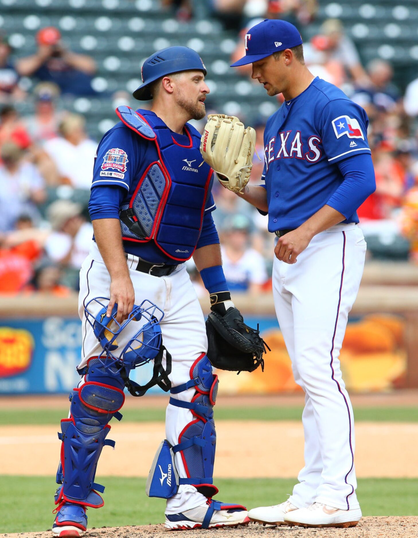 ARLINGTON, TX - JULY 14: Kyle Bird #55 pitcher for the Texas Rangers talks with Tim...