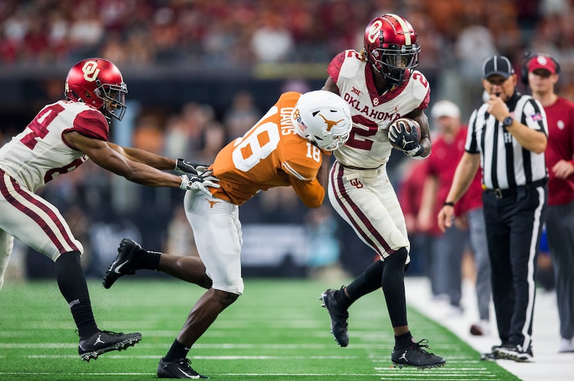 Texas Longhorns defensive back Davante Davis (18) pushes Oklahoma Sooners wide receiver...