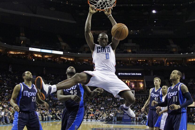 Charlotte Bobcats' Bismack Biyombo (0) dunks against the Dallas Mavericks during the second...
