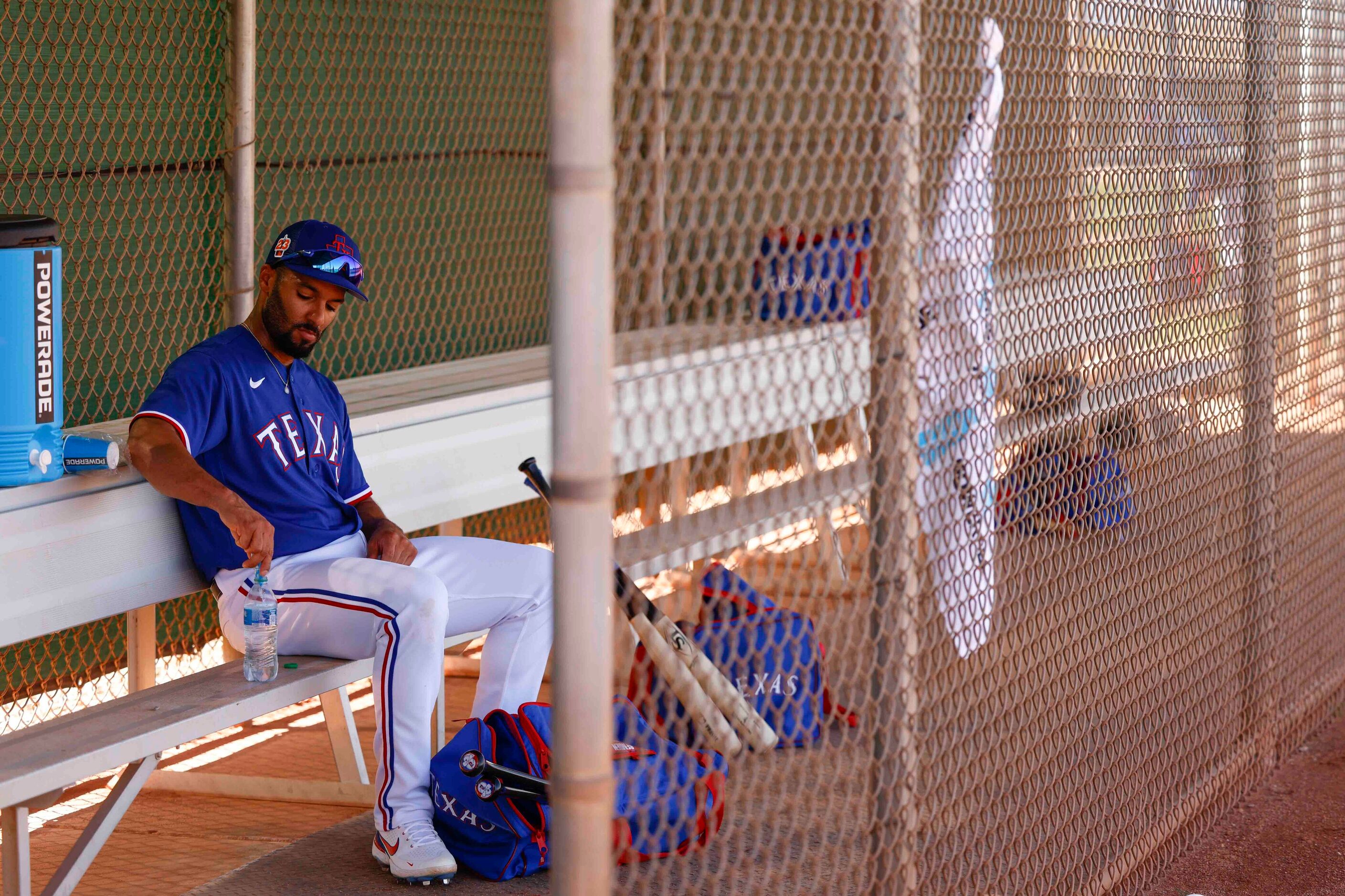 Texas Rangers second baseman Marcus Semien prepares an energy drink in between batting...