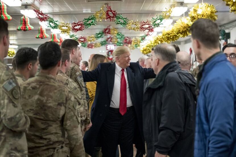 President Donald Trump visits with troops at Al-Asad Air Base in Iraq on Wednesday, December...