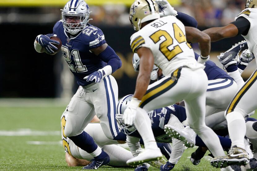 Dallas Cowboys running back Ezekiel Elliott (21) runs up the field as New Orleans Saints...