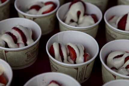 La Madeleine serves strawberries with a rum cream sauce during Bastille on Bishop on July...