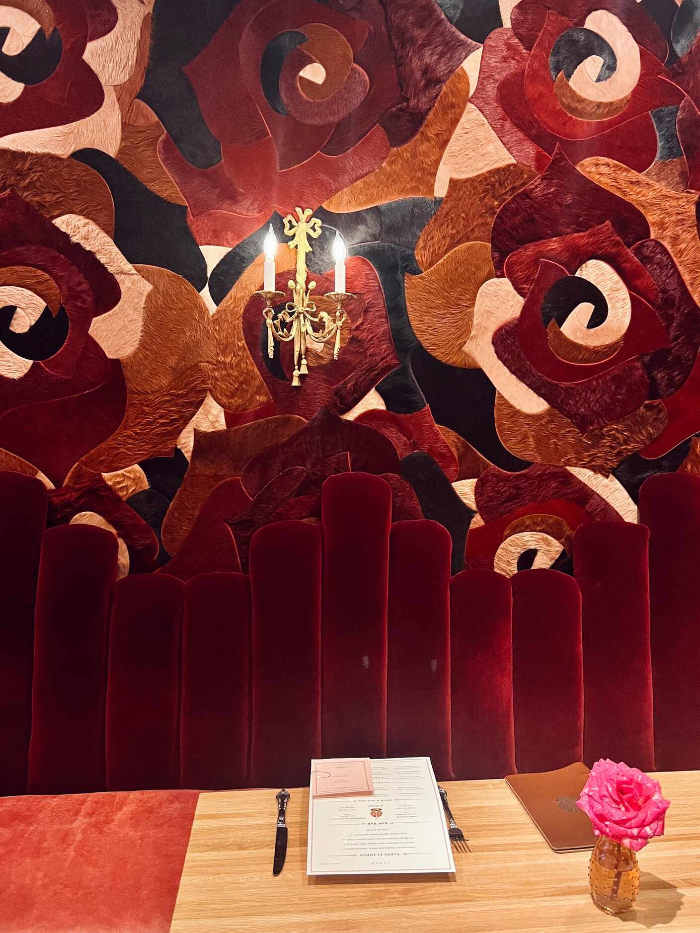 One wall of Le Margot in Fort Worth is covered in cowhide shaped like roses. The restaurant...